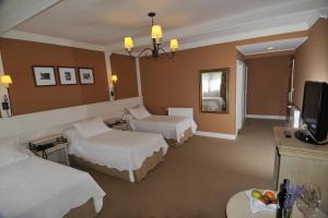 Cama ou camas em um quarto em Hotel Posada Los Alamos