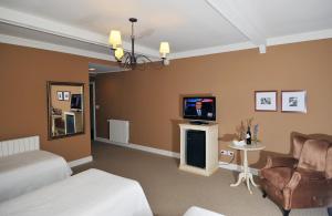 Uma TV ou centro de entretenimento em Hotel Posada Los Alamos