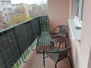 two chairs and a table on a balcony at Apartament Arena in Zgorzelec +5 photos