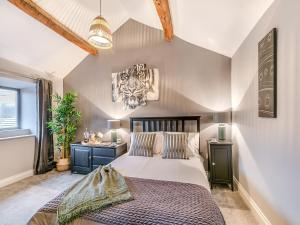 a bedroom with a large bed and a window at Weavers Cottage in Marsden