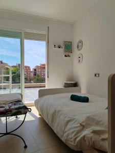 a bedroom with a large bed and a large window at Exclusivo Atico con vistas en el centro de Lorca in Lorca