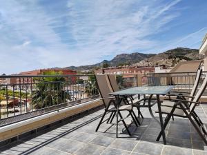 a patio with a table and chairs on a balcony at Exclusivo Atico con vistas en el centro de Lorca in Lorca