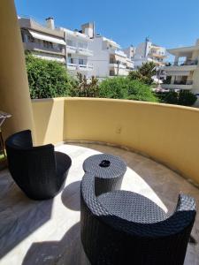 a pair of chairs sitting on a patio at Maria's Sharing Apartment in Heraklio