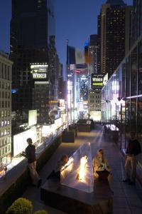 a group of people sitting on top of a building at M Social Hotel Times Square New York in New York