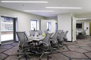 a conference room with a long table and chairs at M Social Hotel Times Square New York in New York