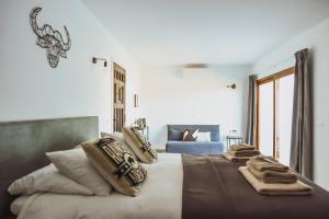 a bedroom with a large bed with blankets and pillows at Boutique B&B Finca Viva la Vida in Alora +37 photos