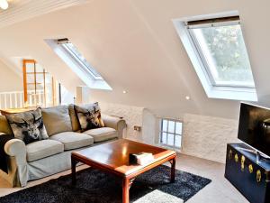 a living room with a couch and a coffee table at Sailor's Cottage in Cramond