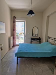 a bedroom with a bed and a large window at Maria's Sharing Apartment in Heraklio