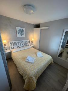a bedroom with a bed with two towels on it at Beach front Esther 1 villajoyosa in Villajoyosa