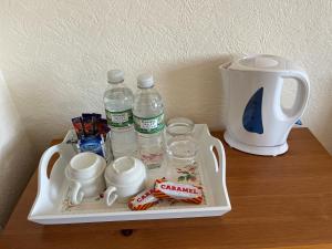 a tray with water bottles and cups on a table at The Island View in Berwick-Upon-Tweed