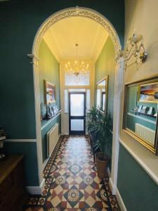 an entry hallway with an archway and a tile floor at The Angove - Adults Only in Weymouth +46 photos