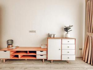 a white cabinet and a dresser in a room at First pool villa พลูวิลล่าโคราช in Nakhon Ratchasima