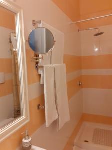 a bathroom with a shower and a mirror at Hotel Guri in Elbasan