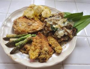 a plate of food with chicken and vegetables on a table at Laurel River Club Bed & Breakfast or LRCBNB in Dryfork