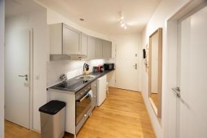 a kitchen with a sink and a stove top oven at Rooftop cozy apartment near innerstadt with AC in Vienna