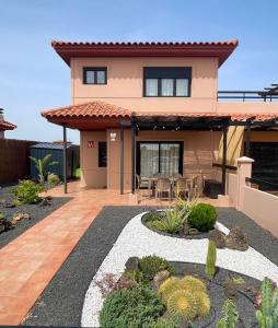a house with a patio in front of it at Villa Twins in Lajares