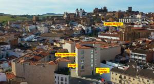 a city with yellow signs on the roofs of buildings at Gran Hotel Don Manuel in Cáceres