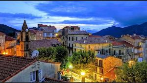 a view of a city at night with buildings at Chez Dume in Santa-Lucia-di-Tallano