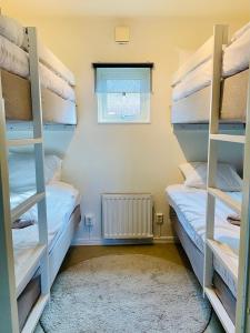 two bunk beds in a room with a window at Hindås Lake Camp in Hindås
