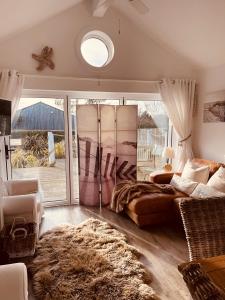 a living room with a bed and a large window at Boardwalk@TheBay, Filey in Filey