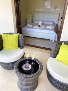 a living room with two chairs and a bed at Villa Oceanview Vicky in Pefkochori