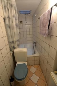 a bathroom with a toilet and a bath tub at Bella Vista in Kavála +20 photos