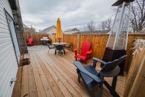 a wooden deck with chairs and a table and an umbrella at Cozy 2-bedroom space in the heart of wine country! in Jordan