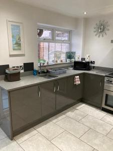 a kitchen with a sink and a counter top at Holiday Home in Cardiff which sleep 5 and we try and make it a home from home in Cardiff