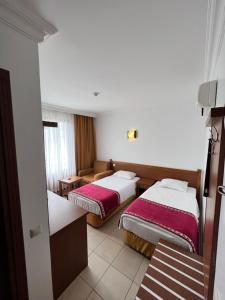 une chambre d'hôtel avec deux lits et un canapé dans l'établissement Hotel Royal Hill, à Antalya