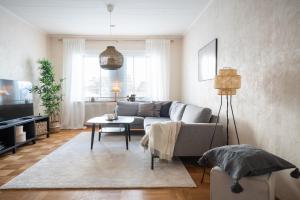 a living room with a couch and a table at Munksund Apartments Villa in Piteå