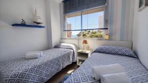 Posteľ alebo postele v izbe v ubytovaní BENICALA sea view apartment
