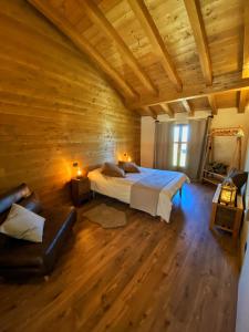 a bedroom with a bed in a wooden room at Ranch Enbrucà in Boves