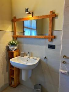 a bathroom with a sink and a mirror at Ranch Enbrucà in Boves +70 photos