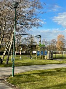 a street light next to a playground in a park at Caravan - Sleeps up to 8 & Free parking in Grange Over Sands