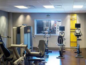 a gym with treadmills and exercise equipment in a building at M Social Hotel Times Square New York in New York