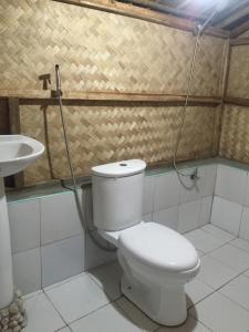 a bathroom with a toilet and a sink at Coco Garden Villas in El Nido
