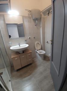 a bathroom with a sink and a toilet at Sweet Home Bari in Bari