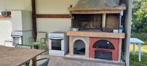 a outdoor pizza oven sitting on a patio at Petasos Apartments 1 in Gennadi