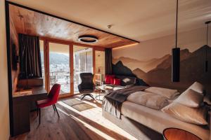 a bedroom with a mountain mural on the wall at Dilly - Das Nationalpark Resort in Windischgarsten