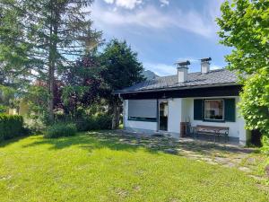 a white house with a bench in a yard at Holiday home in Bad Mitterndorf - Steiermark 41114 in Bad Mitterndorf