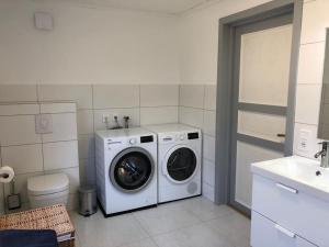 a white washer and dryer in a bathroom at Ferienhaus in Borghamn, Vättern in Borghamn