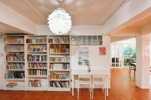 une bibliothèque avec des étagères blanches remplies de livres dans l'établissement Your Home AYUTTHAYA ยัวร์โฮม, à Phra Nakhon Si Ayutthaya