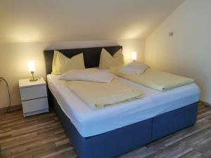 ein Schlafzimmer mit zwei Betten mit zwei Lampen in der Unterkunft Ferienwohnungen Scheid Volker in Sankt Aldegund