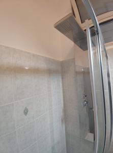 a bathroom with a shower with a ceiling at Sweet Home Bari in Bari