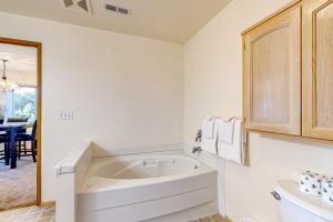 a white bathroom with a large bath tub in it at La Cana Street Leisure In Law Suite in Coupeville