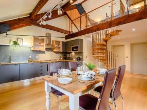 a kitchen and dining room with a table and chairs at Woodmill Bakewell Riverside in Bakewell