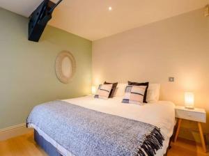 a bedroom with a bed with pillows on it at Woodmill Bakewell Riverside in Bakewell