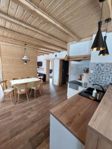 a kitchen and dining room with a table in a room at Domek nad Solinką in Żubracze