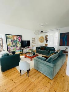 a living room with two couches and a tv at Maison de charme de 280m2 avec piscine chauffée … in Luçon