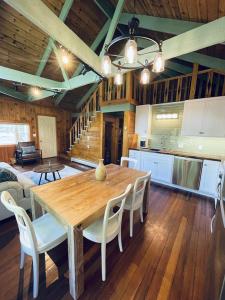 a kitchen and dining room with a wooden table and chairs at Chalet with a Private Beach in Acadia National Park in Bar Harbor